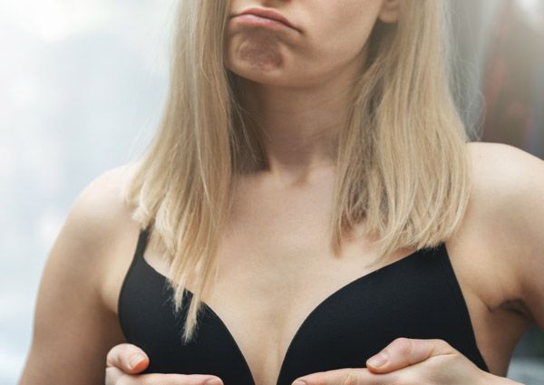 women looking at her reflection pouting